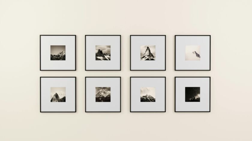 Black and white mountain framed photos on a wall